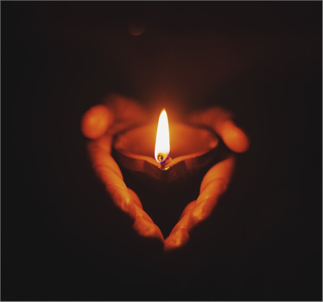 hands holding candle