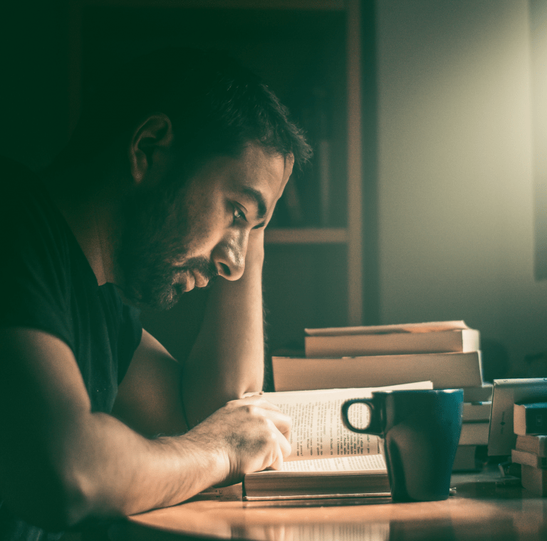 Man studying in a dark room