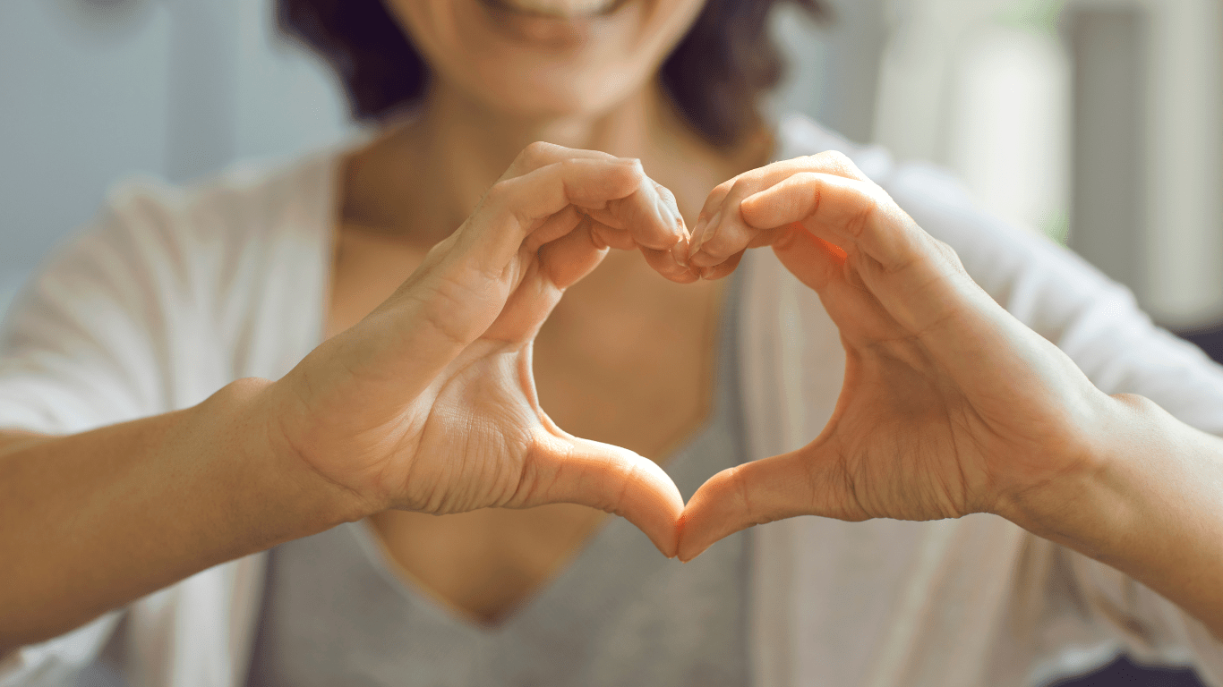 A picture of a woman's hands that are forming the shape of a heart